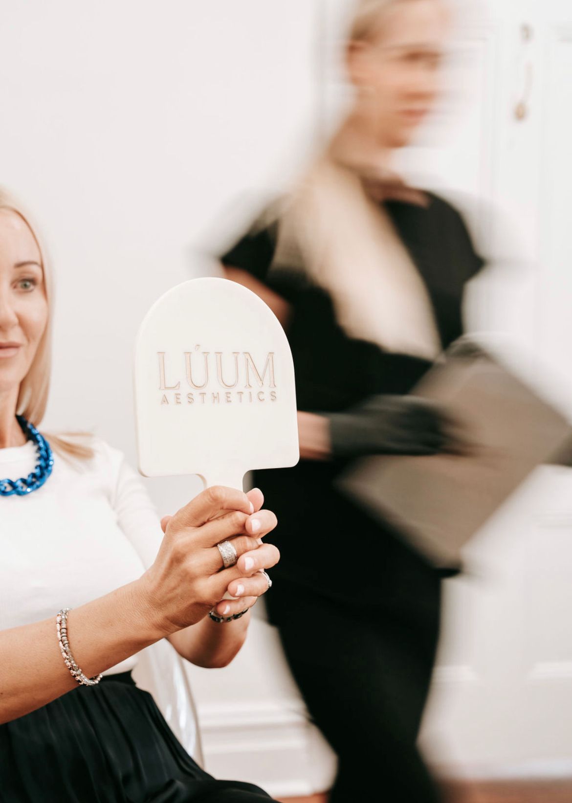 Beauty Salon Photo Shoot with Customer holding Personalised Handheld Mirror with Custom Branding for Luum Aesthetics - Boho & Brave Perth