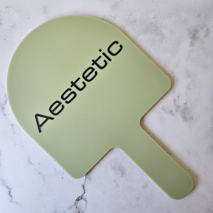 Custom Handheld Mirror with Logo for Aesthetic Injectable Clinic - Arch handheld mirror in eucalyptus green acrylic with Black Logo