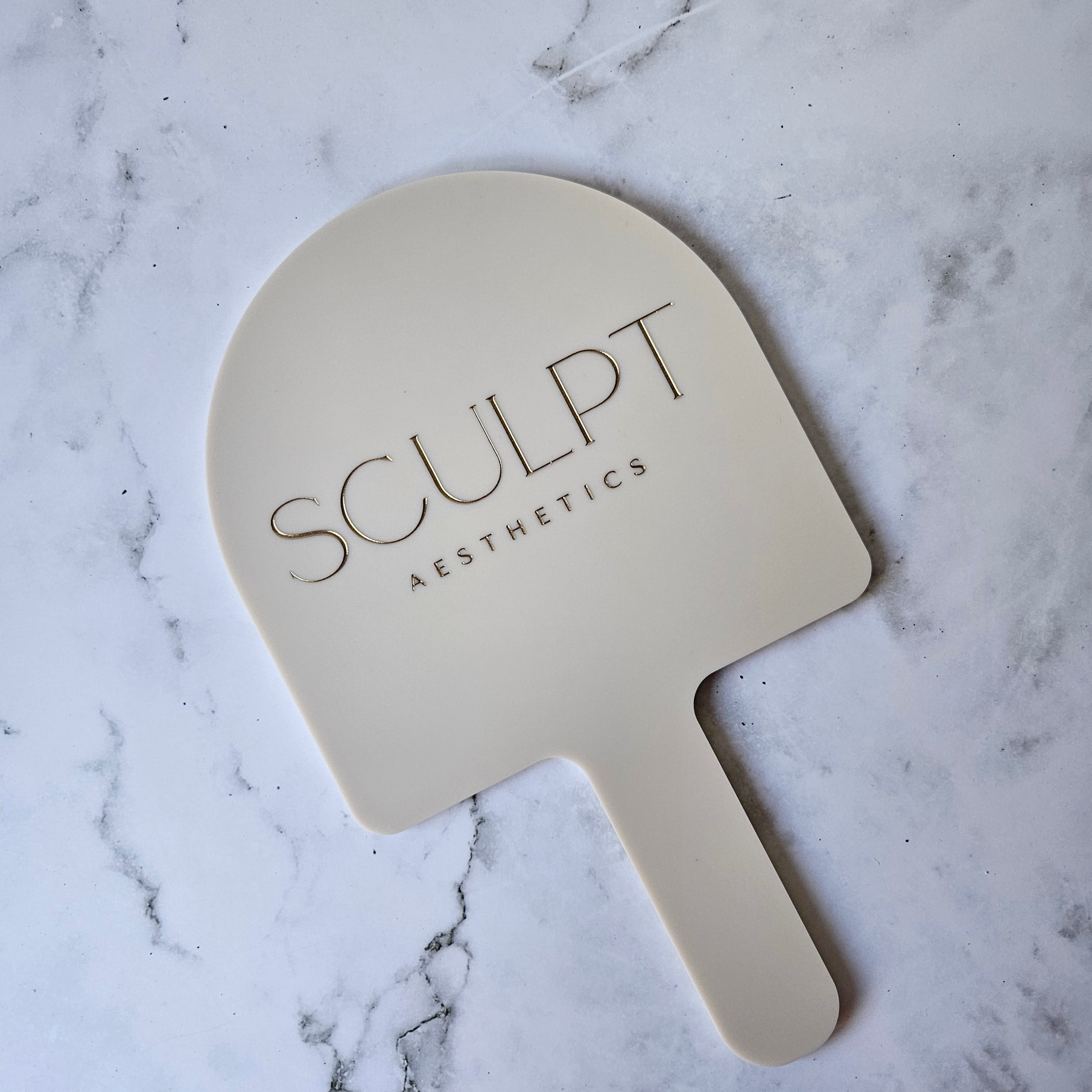 Custom Handheld Mirror with Logo for Injectable Clinic - Arch handheld mirror in beige acrylic with Gold logo