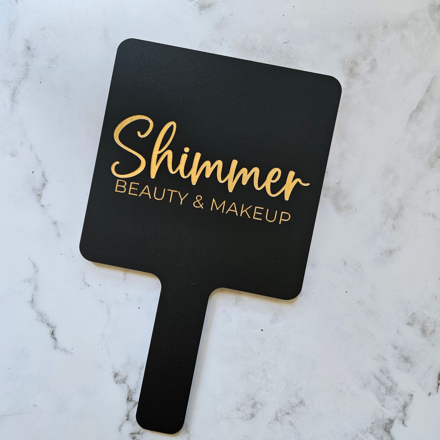 Square handheld mirror in black with gold logo engraving for beauty and makeup artist australia