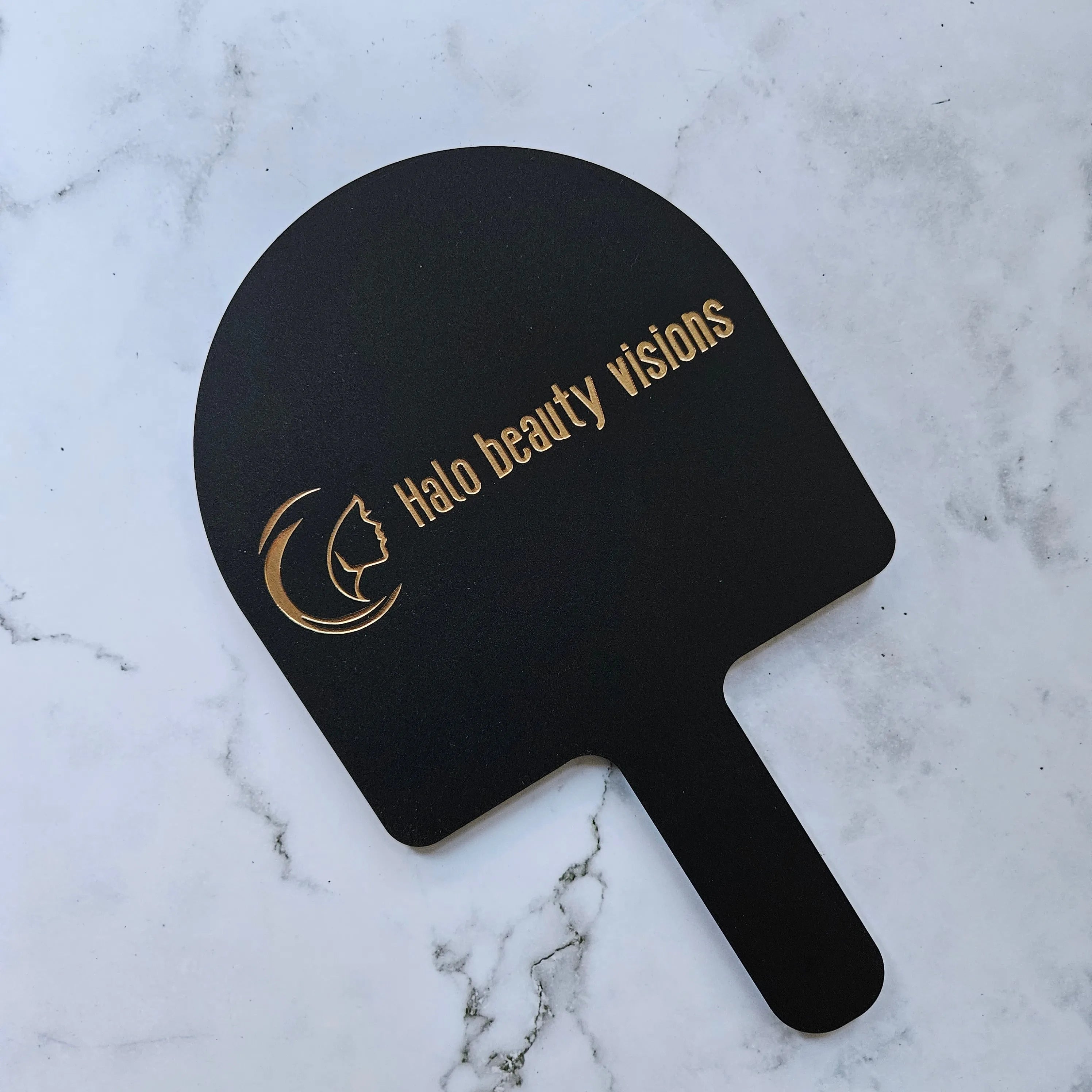 Arch handheld mirror in black with gold logo custom for beauty and cosmetic tattoo salon