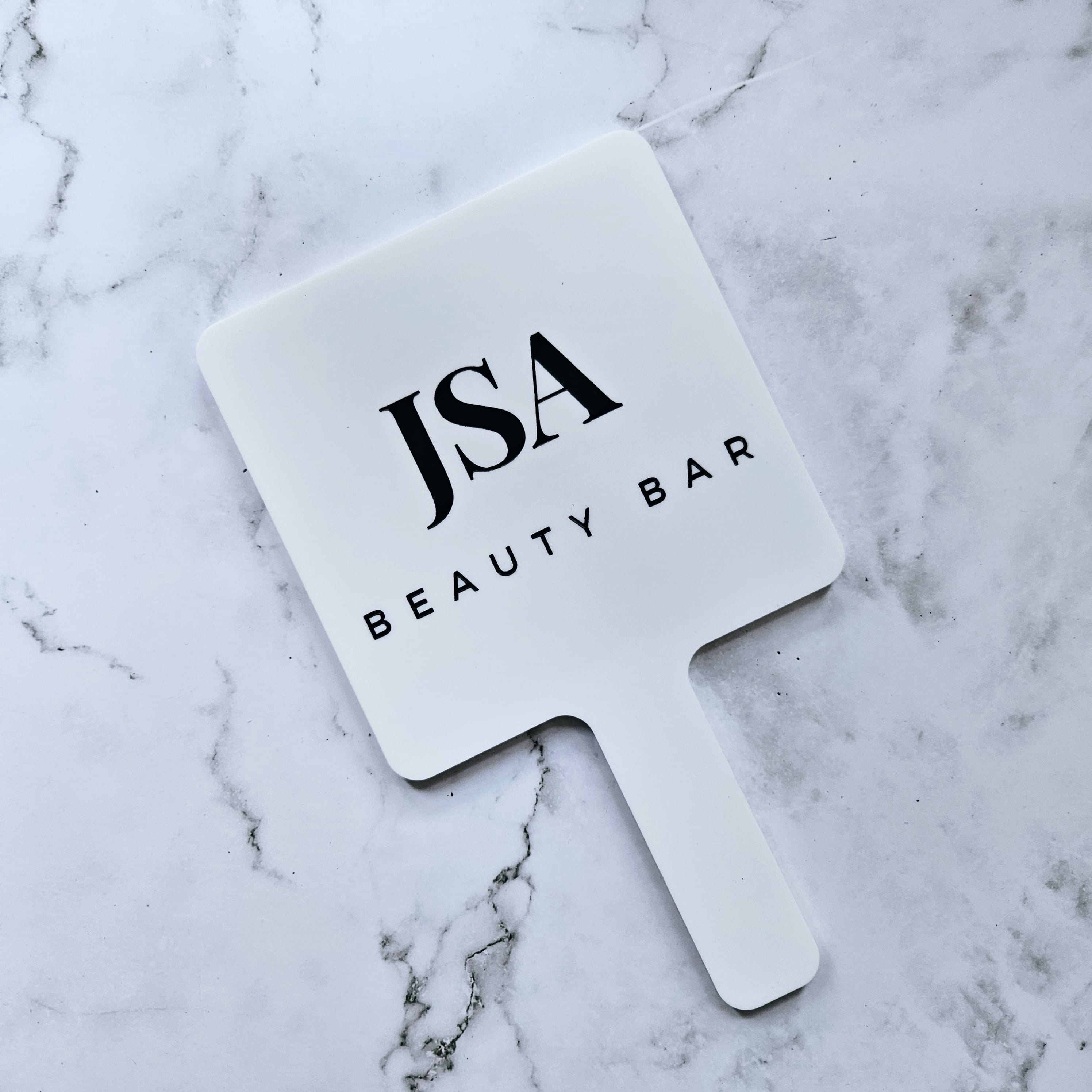 Square Handheld Mirror in white acrylic with custom black logo for beauty salon