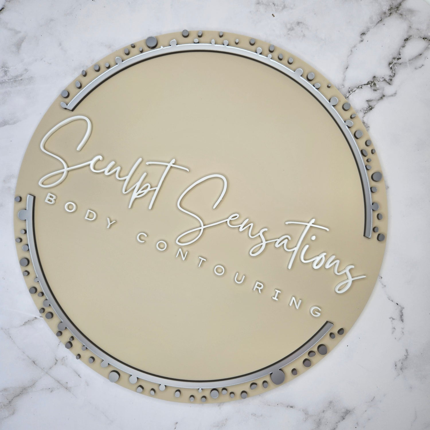 Round 3D Acrylic Business Logo Sign with a nude base and 3D Body Contouring in White and Silver acrylic
