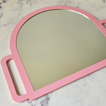 hand held mirror showcasing glass