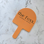 Custom Handheld Mirror with Logo for Cosmetic Tattoo Clinic - Arch handheld mirror in pastel orange acrylic with Black Logo