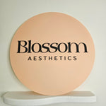 Round Business Sign in Peach Fizz with Black Acrylic Letters