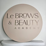 Round business sign with brushed brown acrylic letters