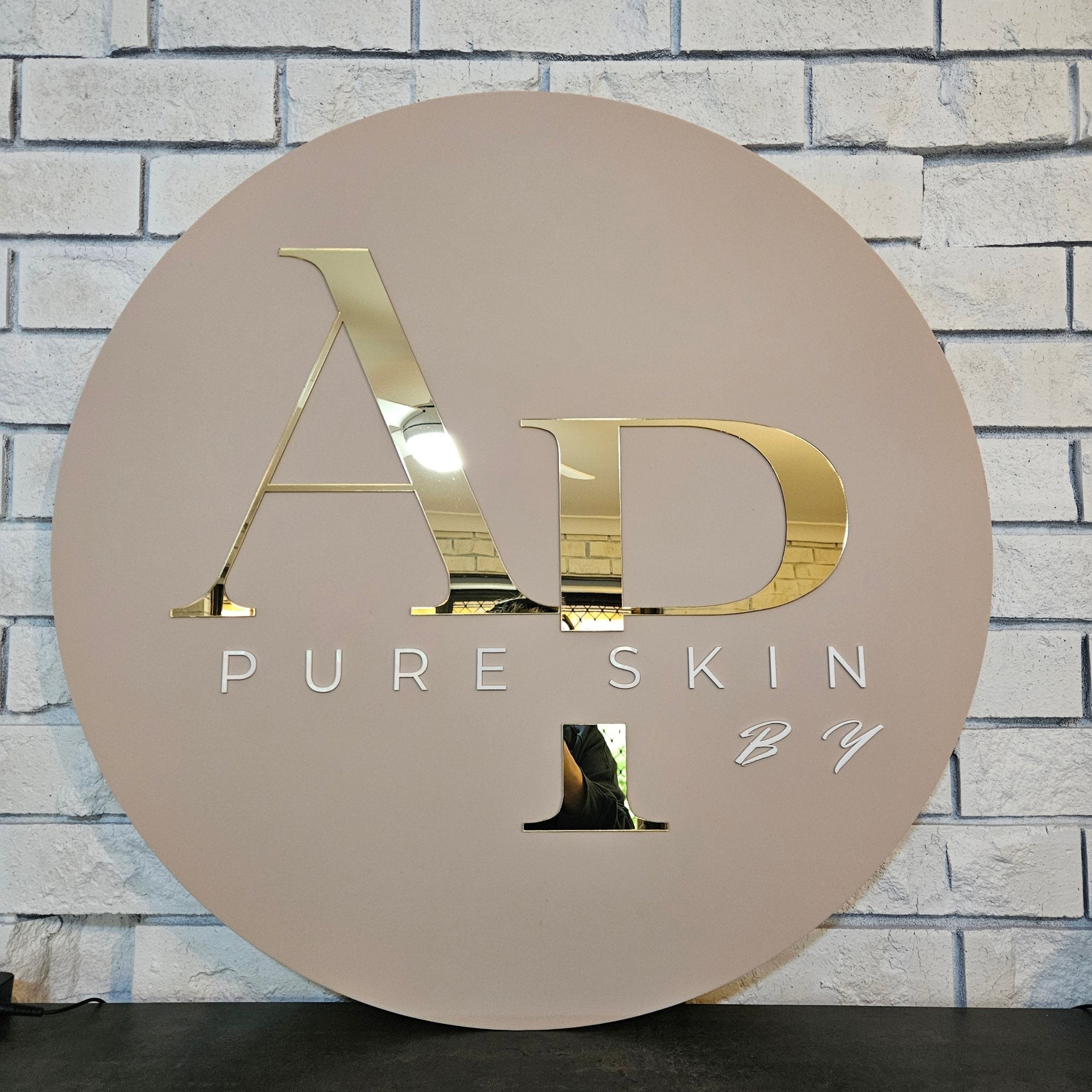 Round business sign with gold letters