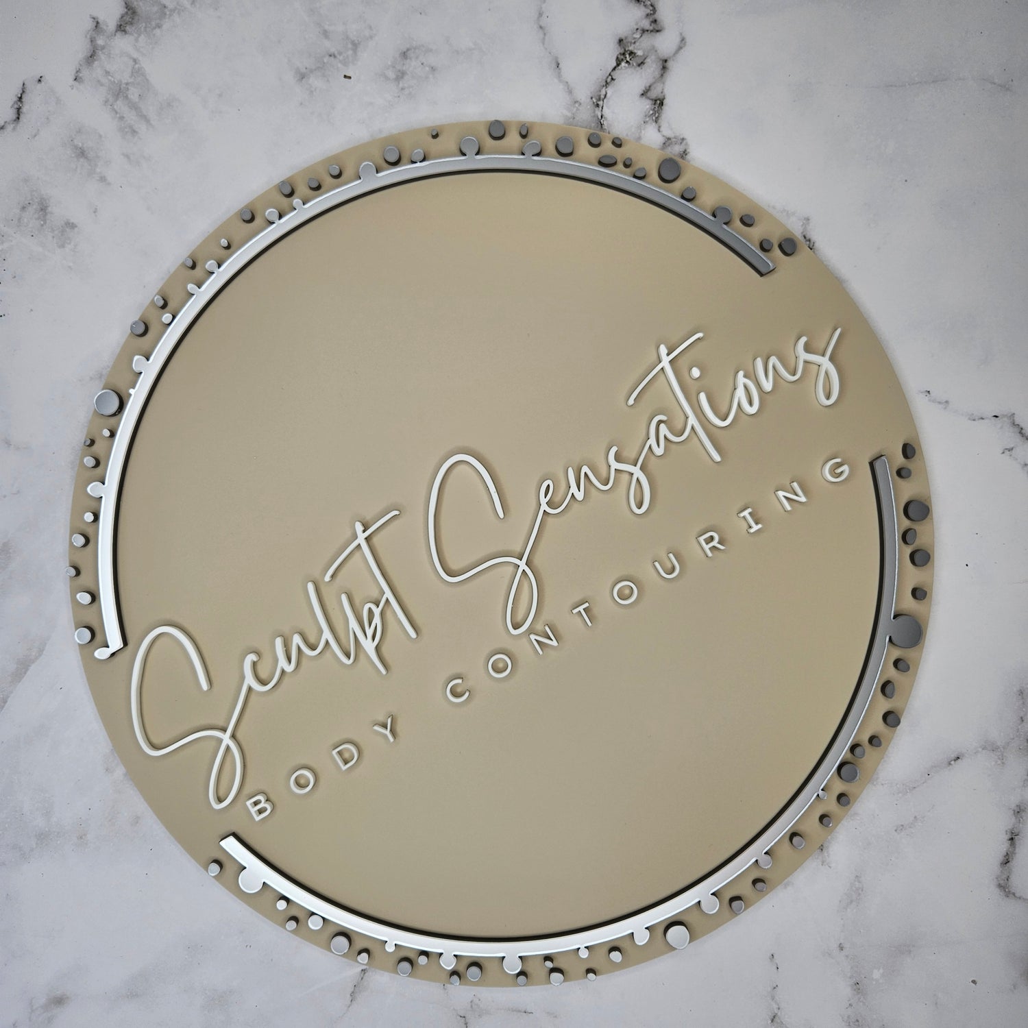 Round 3D Acrylic Business Logo Sign with a nude base and 3D Body Contouring in White and Silver acrylic