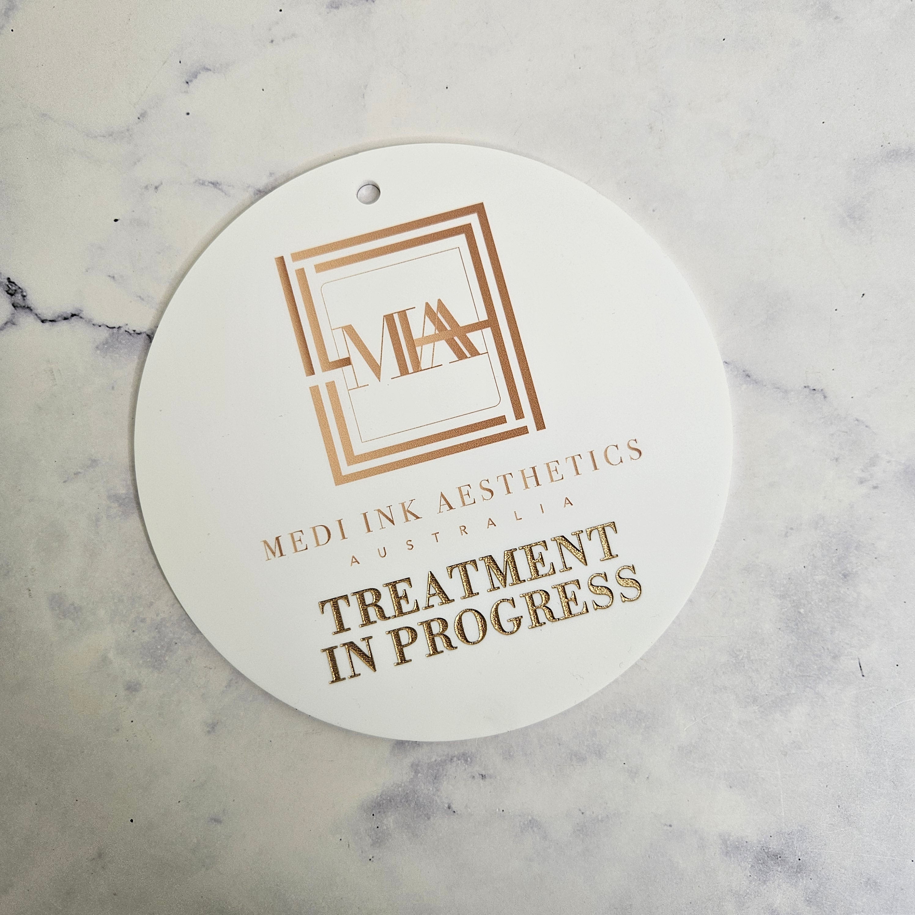 Treatment in progress sign with gold engraving