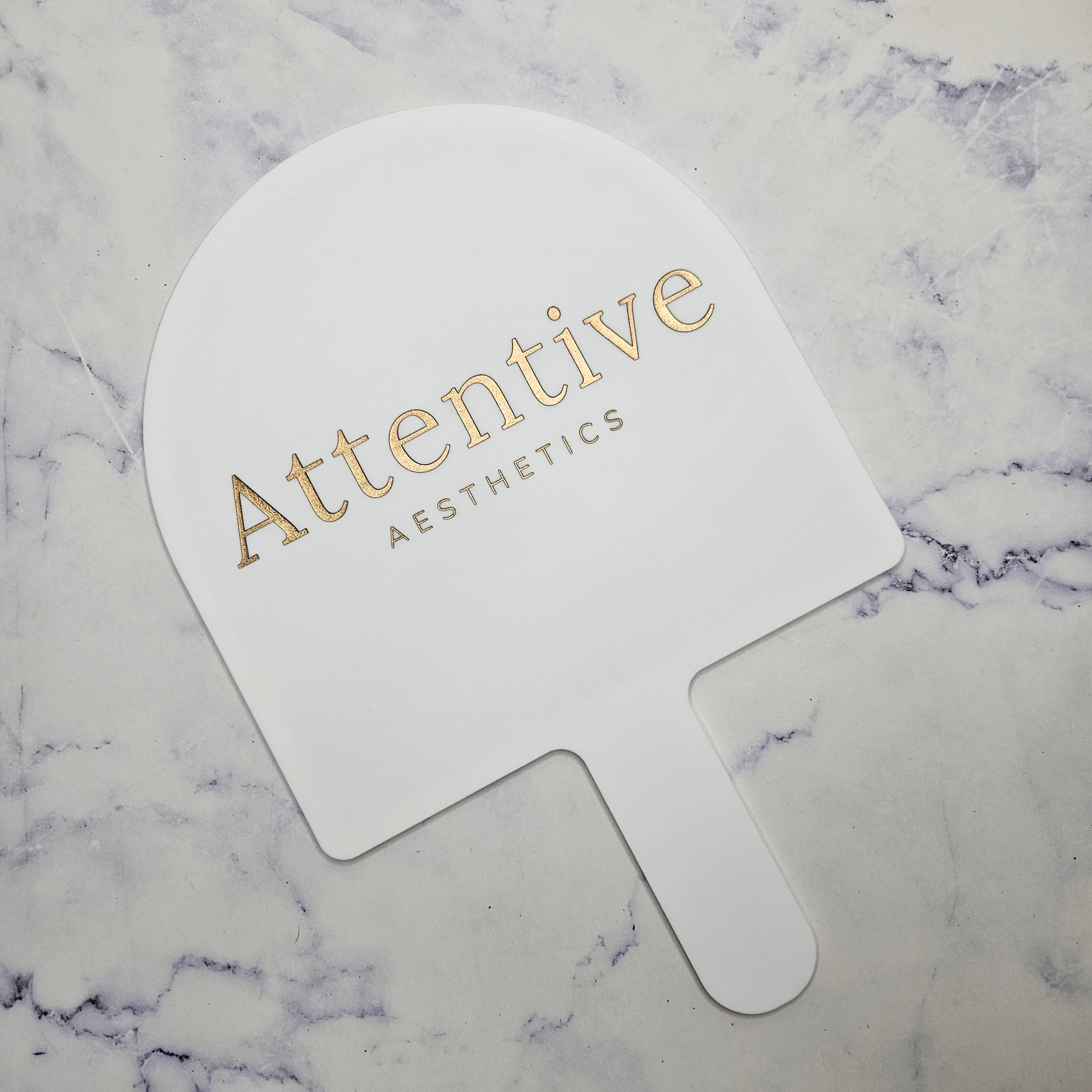 XL Arch Handheld Mirror in white acrylic with Gold Logo