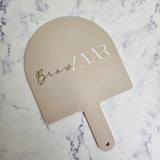 XL Arch Handheld Mirror in almond acrylic with gold & white logo