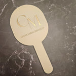 Oval Handheld Mirror in nude acrylic with gold engraved logo