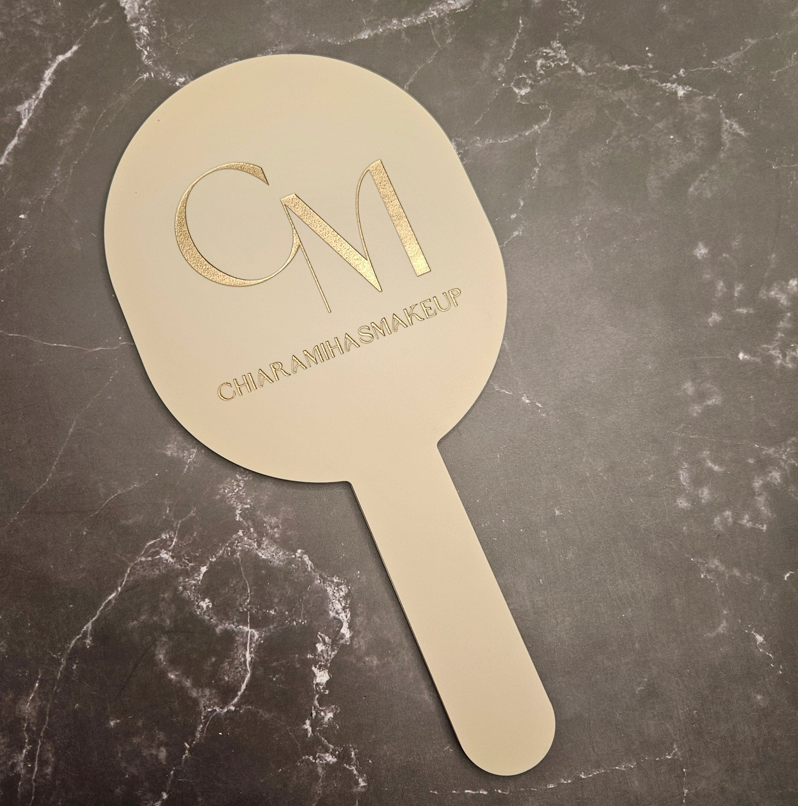 Oval Handheld Mirror in nude acrylic with gold engraved logo