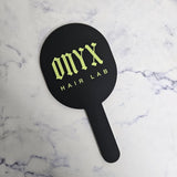 Oval handheld mirror in black acrylic with lime green logo