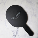 Oval handheld mirror with white logo