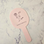 Oval handheld mirror with black logo and baby pink acrylic