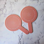 Round Handheld Mirror in Pink Clay Acrylic with White Logo