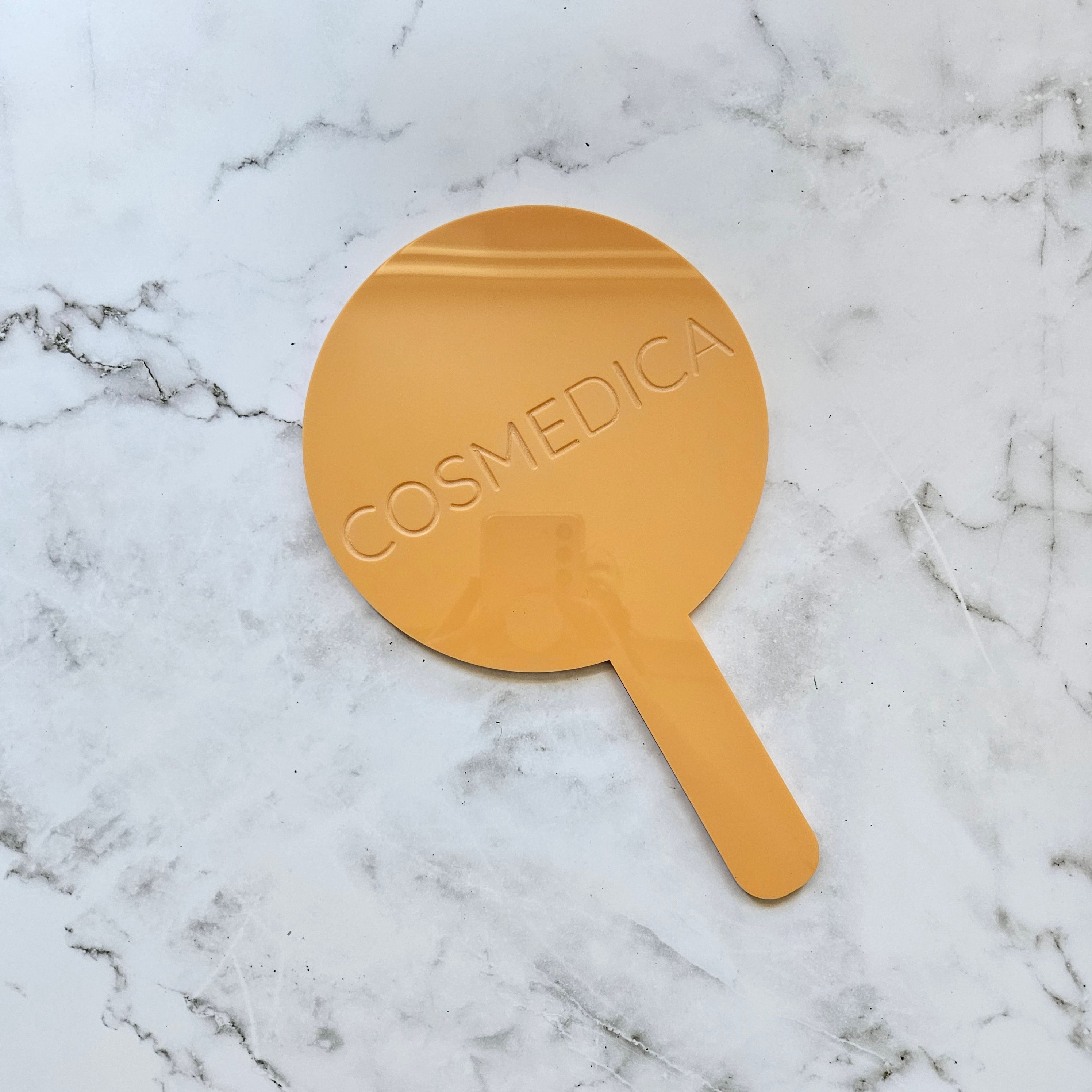 round handheld mirror (gloss pastel orange) with engraved logo